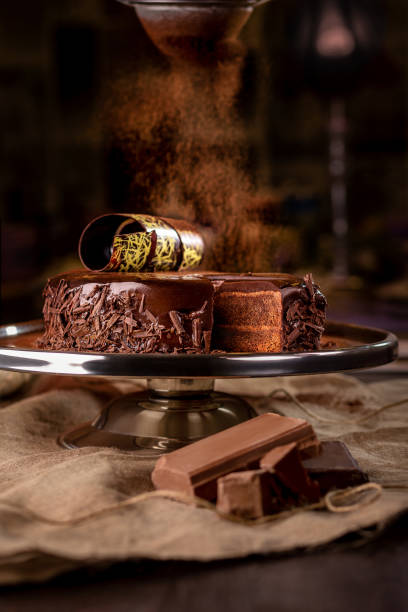 istock Chocolate biscuit cake with buttercream and ganache sprinkled with cocoa 2162230565