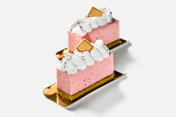 Chocolate mousse is piped into tartlet shells from a pastry bag, topped with raspberries for a delightful finish