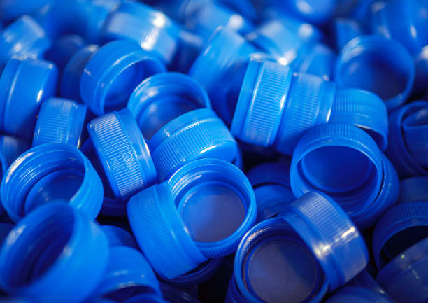 Close-up of blue plastic bottle caps.Recycling collection and production processing plastic bottle caps background ,Industrial production of bottle caps made of blue high-density polyethylene.
