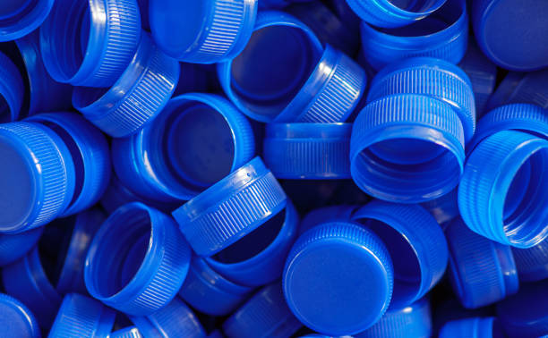 istock Top view blue plastic bottle caps.Recycling collection and production processing plastic bottle caps background ,Industrial production of bottle caps made of blue high-density polyethylene. 2162231735