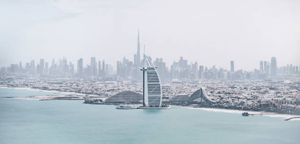 Burj Al Arab in Dubai seen at sunset in United Arab Emirates. In the far background Burj Khalifa.