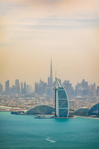 Burj Al Arab in Dubai seen at sunset in United Arab Emirates. In the far background Burj Khalifa.