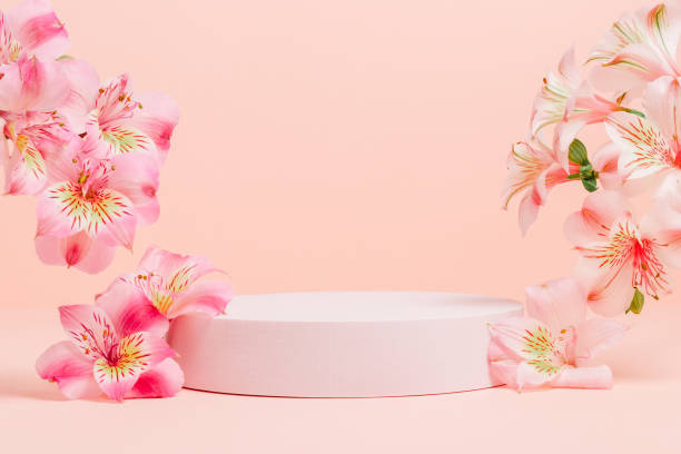 istock Empty podium with pink flowers on pink background. 2162233390