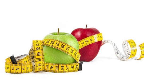 istock Red and Green Apples with Tape Measure 2162233483