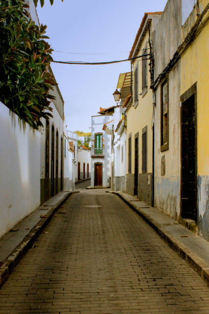 istock old street in a town with blue sky - vertical 2162234968
