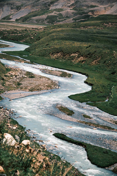 istock Light-blue beautiful river spreading along summer mountain valley 2162235174