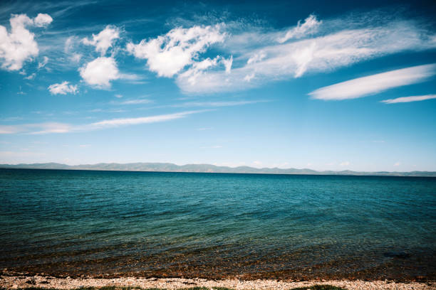 Bay of Lake Baikal, Russia - August , 2021: View of Lake Baikal from the slope of the rock Skriper. Not far from the Great Baikal Trail. Pribaikalsky National Park, Irkutsk region. August.