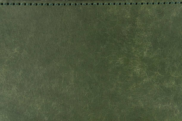 istock Green leather surface with stitching  on the top and copyspace. 2162236532