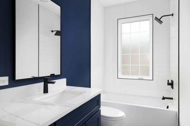 istock A blue bathroom with a white subway tile shower. 2162237309