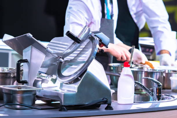 istock Slicer in the restaurant kitchen. Concept - Slicer washed with detergent. Detergent for kitchen appliances. Professional semi-automatic slicer. Machine with a cutting disc. Grocery Store Equipment. 2162238921