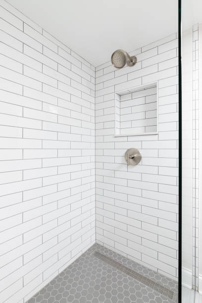 istock A shower with white subway and grey hexagon tiles. 2162238973