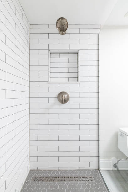 istock A shower with white subway and grey hexagon tiles. 2162239089