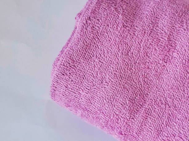 istock close up of folded towel. textured. textile. blue. pink 2162239097