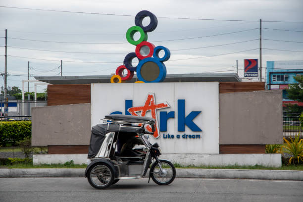 Antipolo City, Philippines - April 14, 2020: A tricycle filled with food supplies cross an empty road during the lockdown due to Covid 19 virus outbreak.