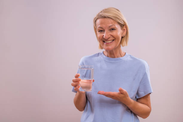 istock Mature  woman drinking water 2162239947