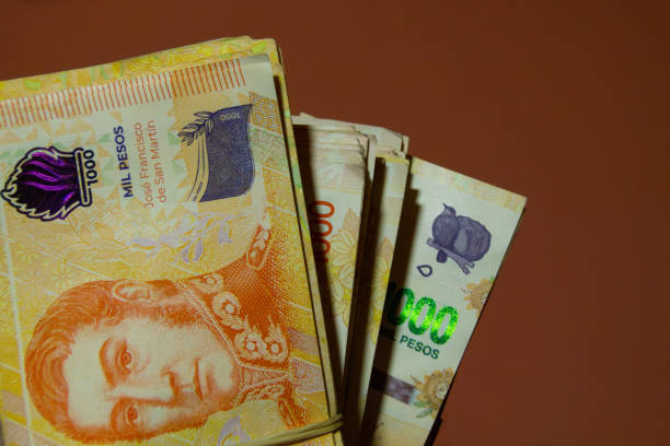 istock several wads of Argentine peso bills 2162240237