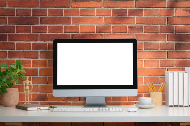 istock Comfortable workplace with blank computer screen, houseplant and stationery. 2162241664