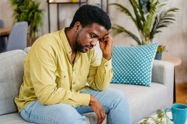 istock Sad Young Man Sitting At Home On The Sofa 2162242678