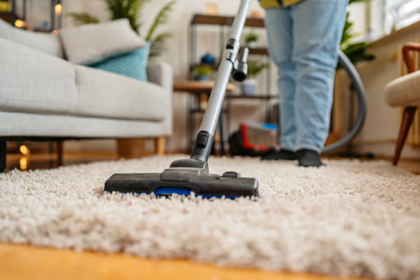 istock Young Man Vacuuming The Carpet In His Apartment 2162242871