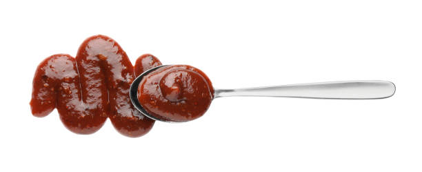 istock Tasty barbecue sauce and spoon isolated on white, top view 2162243065