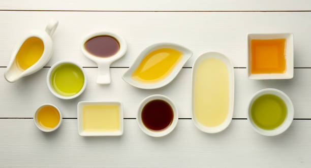 istock Vegetable fats. Different cooking oils on white wooden table, flat lay 2162243091