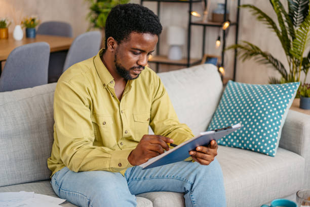 istock Young Man Checking His Finances At Home 2162243125