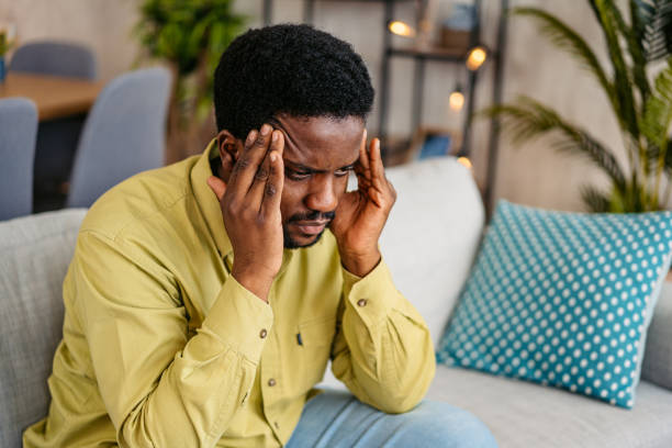istock Young Man Having A Headache At Home 2162243924