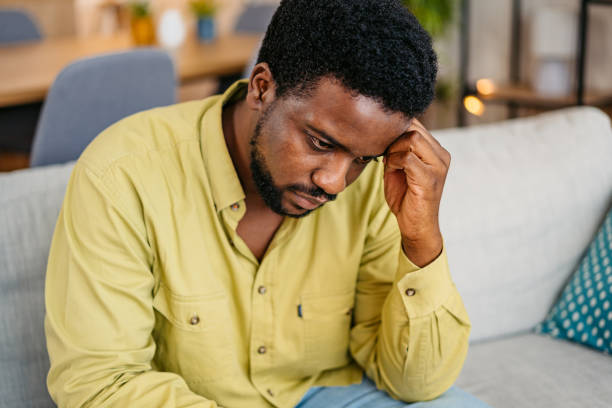istock Sad Young Man Sitting At Home On The Sofa 2162244008