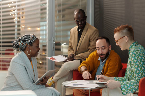 istock Diverse Group Reviewing Reports during Office Meeting 2162244187