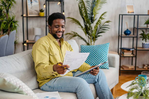 istock Young Man Checking His Finances At Home 2162244468