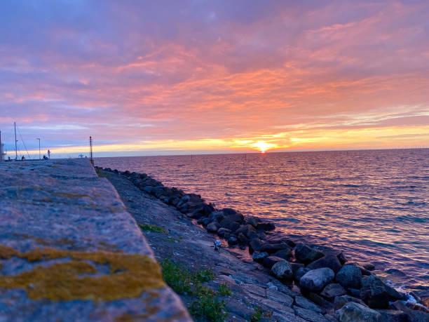 Sunset over the rocky pier.
