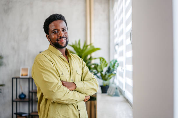 istock Young Man Standing By The Window At Home 2162244767