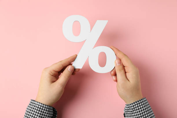 istock Man holding percent sign on pink background, top view 2162245833