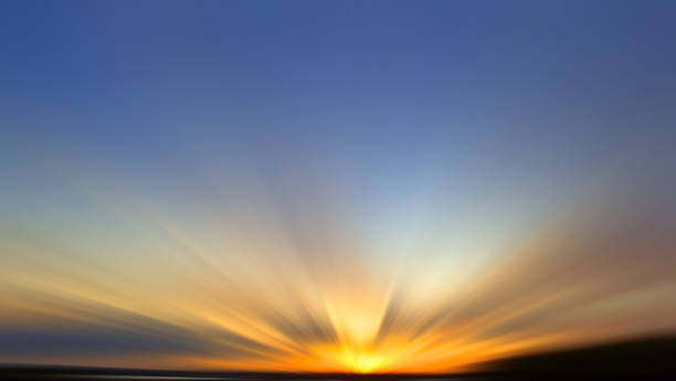 Sunset sky background. Blue sky with golden light and clouds with soft blur motion effect backgrounds. Sky clouds backdrop.