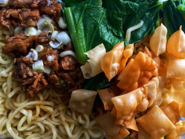 Mie ayam (noodles with chicken, meatballs, dumplings and vegetables) is a popular street food in Indonesia.