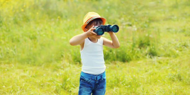 istock Little boy child looking through binoculars outdoors on summer day 2162252755