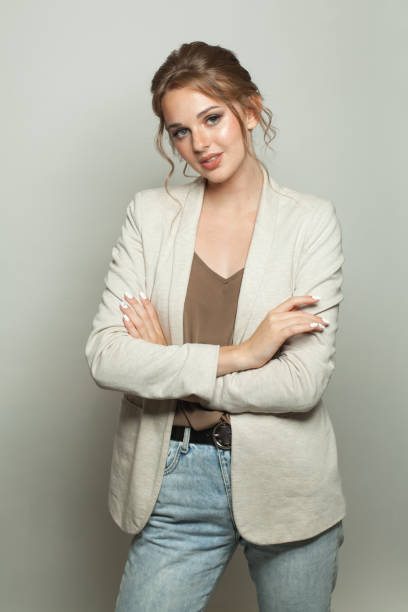 istock Gorgeous casual model woman wearing light jacket standing against white studio wall background 2162253972