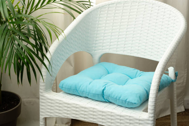 White Wicker Patio Chair With Cushion In Home Setting Close Up