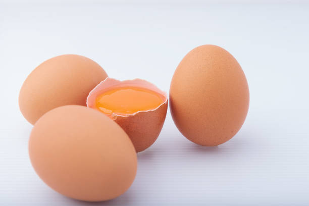 Three Brown Chicken Eggs Arranged On Clean White Background With Shallow Depth Of Field, Representing Natural Food, Organic Nutrition, Minimalist Still Life, And Simple Studio Composition.