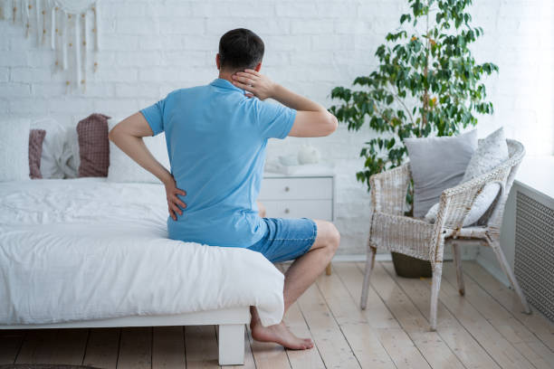 Lumbar and cervical spine hernia, man with back pain at home, compression injury of the intervertebral disc Lumbar and cervical spine hernia, man with back pain at home, compression injury of the intervertebral disc, health problems concept kyphosis stock pictures, royalty-free photos & images