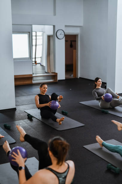 istock Female Athletes Smiling While Working On Abdominal Muscles With Pilates Mini Ball 2162258298