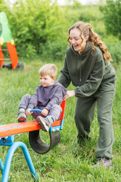istock Mother and Son Playing on Seesaw. 2162259027