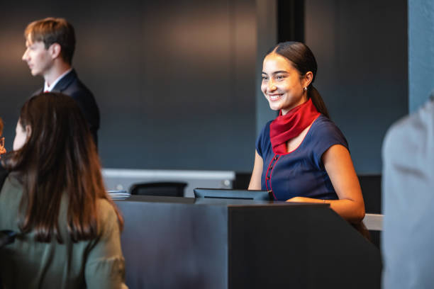 istock Smiling Female Flight Attendant At The Check-in Counter 2162259506