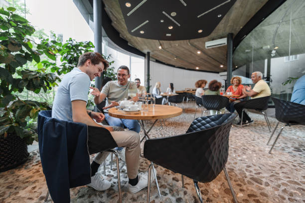 istock Happy Diverse Friends Laughing At A Modern Coffee Shop 2162260249