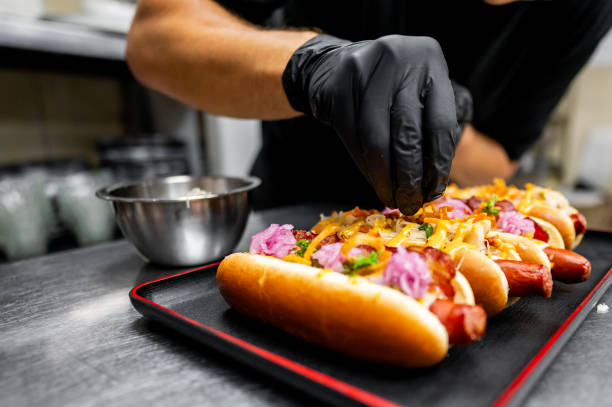 istock Chef hand cooking set hot dog on kitchen 2162265887