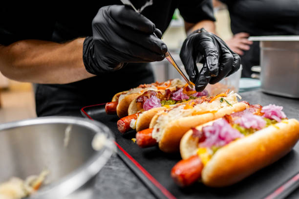 istock Chef hand cooking set hot dog on kitchen 2162265898