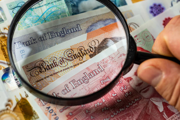 British pounds viewed under a magnifying glass, Concept, UK economics and finance, close up British pounds viewed under a magnifying glass, Concept, UK economics and finance british currency stock pictures, royalty-free photos & images