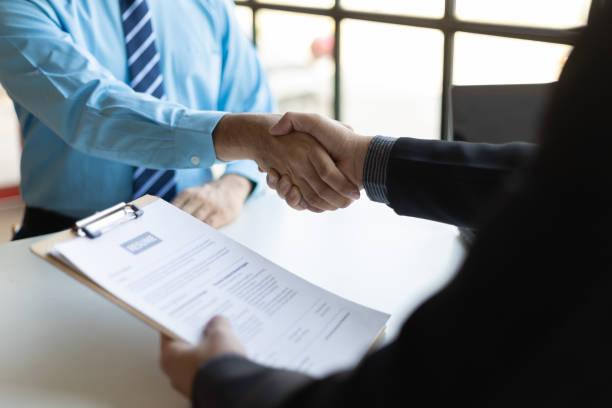 istock Employees shake hands after finishing a job interview. 2162271977