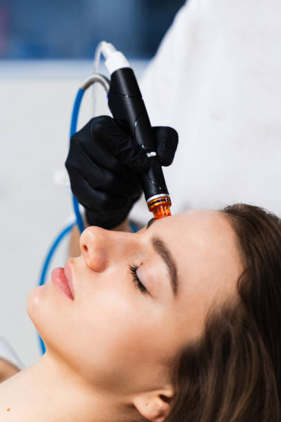istock Rejuvenating skin with Hydradermabrasian hardware. Using Hydradermabrasian hardware cosmetology devise to improve skin condition. 2162274186
