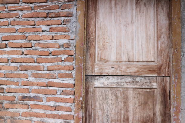 istock Half frame wooden brown door and brick wall 2162277333